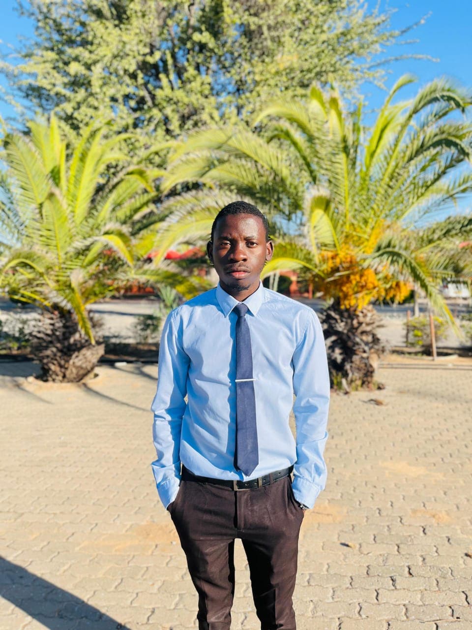 Kudumo Kupembona Andreas in a centered formal outdoor portrait