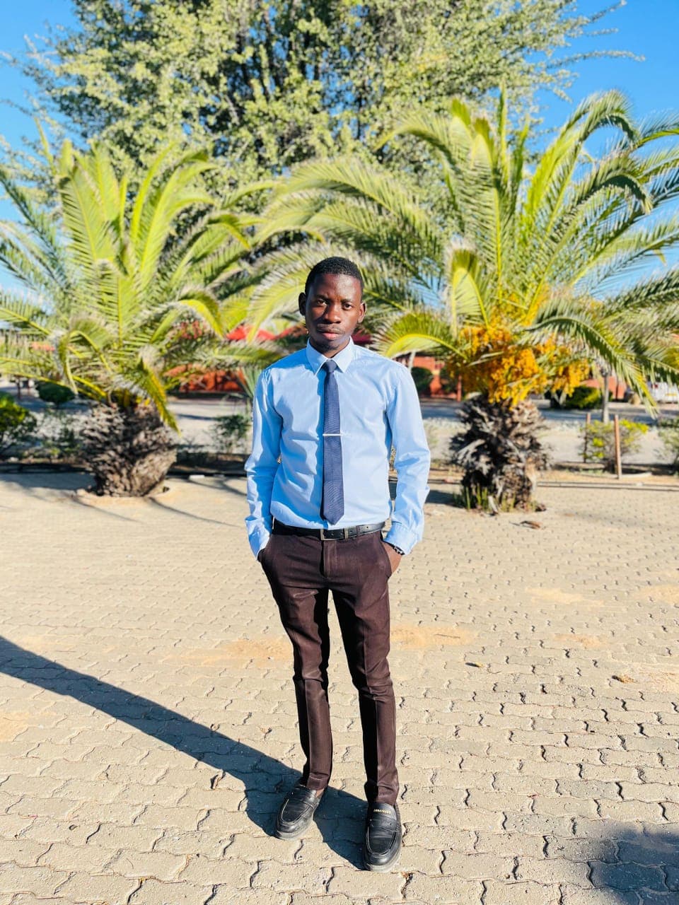 Kudumo Kupembona Andreas in formal business attire outdoors