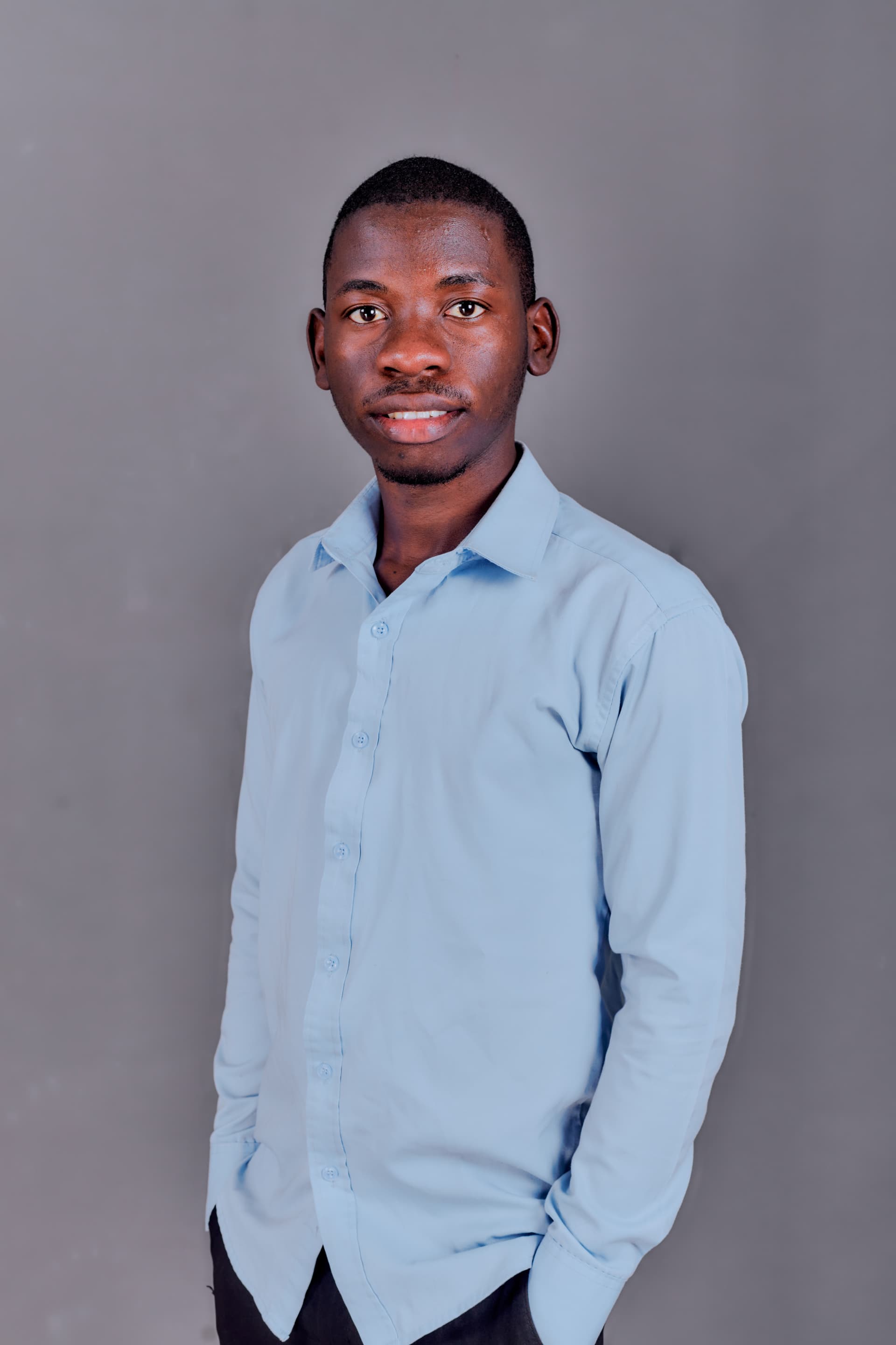 Kudumo Kupembona Andreas in a studio portrait wearing a light blue shirt