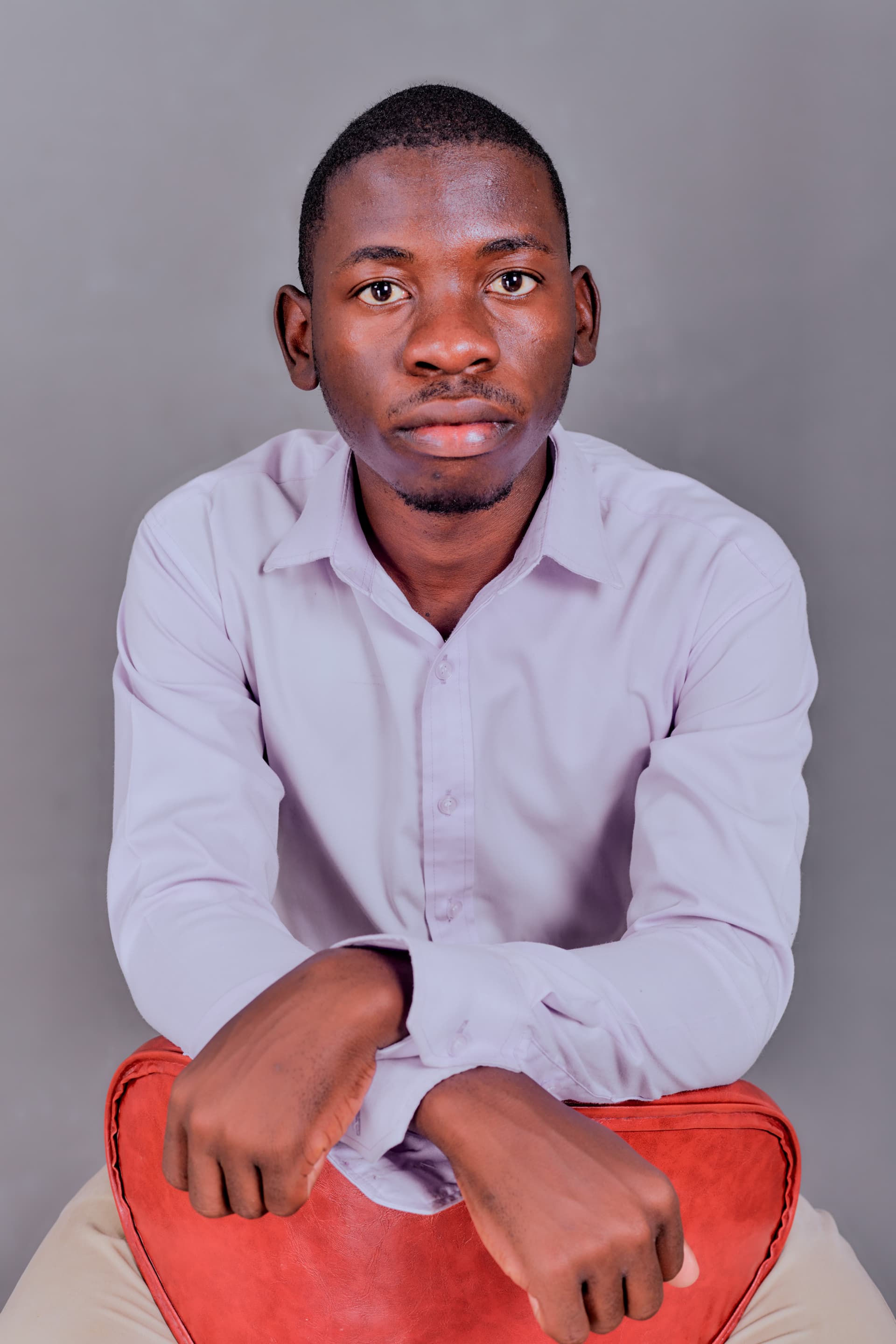 Kudumo Kupembona Andreas seated in a studio portrait